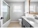 Well-lit bathroom featuring a gray vanity, framed mirror and shower/tub combo, providing a relaxing and functional space at 2872 N Prairie Stream Way, Columbus, IN 47203