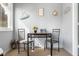 Bright dining area with a small table and stylish chairs, complemented by charming nautical-themed decor at 2872 N Prairie Stream Way, Columbus, IN 47203