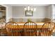 Elegant dining room with a large wooden table and stylish chandelier at 2872 N Prairie Stream Way, Columbus, IN 47203