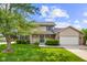 Charming two-story home with a well-manicured lawn, inviting porch, and attached two-car garage at 2872 N Prairie Stream Way, Columbus, IN 47203