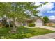Charming two-story home with front porch, attached garage, mature tree, and well-maintained lawn at 2872 N Prairie Stream Way, Columbus, IN 47203