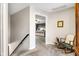 Upstairs hallway that leads to a well-lit bedroom with a rocking chair at 2872 N Prairie Stream Way, Columbus, IN 47203