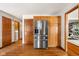 Bright kitchen features stainless steel fridge, hardwood floors, and ample cabinet space at 2872 N Prairie Stream Way, Columbus, IN 47203