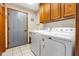 Functional laundry room with new washer and dryer, storage cabinets at 2872 N Prairie Stream Way, Columbus, IN 47203
