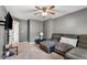 Relaxing living room featuring gray walls, carpet, a ceiling fan, tv, and a plush sectional sofa for cozy lounging at 2872 N Prairie Stream Way, Columbus, IN 47203