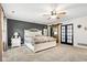 Spacious main bedroom with a ceiling fan, and picture window, offering a serene retreat for relaxation and rest at 2872 N Prairie Stream Way, Columbus, IN 47203