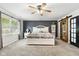 Spacious main bedroom with a ceiling fan, and picture window, offering a serene retreat for relaxation and rest at 2872 N Prairie Stream Way, Columbus, IN 47203