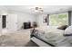 Spacious main bedroom with a ceiling fan, and picture window, offering a serene retreat for relaxation and rest at 2872 N Prairie Stream Way, Columbus, IN 47203