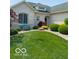 Charming single-story home featuring a well-manicured lawn, mature landscaping, and light brick exterior at 3354 Nottinghill Dr, Plainfield, IN 46168