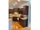 Well-appointed kitchen with dark wood cabinets, stainless steel appliances, and a granite counter at 3354 Nottinghill Dr, Plainfield, IN 46168