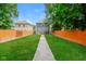 Spacious backyard with well-maintained lawn and a long concrete walkway at 3626 N Capitol Ave, Indianapolis, IN 46208
