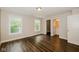 Cozy bedroom featuring luxury vinyl floors, neutral walls, with an attached bathroom, and walk in closet at 3626 N Capitol Ave, Indianapolis, IN 46208