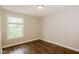 This bedroom features new flooring and a large bright window at 3626 N Capitol Ave, Indianapolis, IN 46208