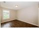 This bedroom features new flooring and a large bright window at 3626 N Capitol Ave, Indianapolis, IN 46208