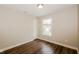 This bedroom features new flooring and a large bright window at 3626 N Capitol Ave, Indianapolis, IN 46208