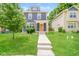 Charming blue two-story home featuring a bright orange front door, well-manicured lawn, and welcoming walkway at 3626 N Capitol Ave, Indianapolis, IN 46208