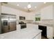 Well-lit kitchen featuring stainless steel appliances, white cabinets, granite countertops, and luxury vinyl plank flooring at 3626 N Capitol Ave, Indianapolis, IN 46208