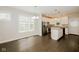 Bright dining area featuring luxury vinyl floors and views into a kitchen with stainless appliances and a kitchen island at 3626 N Capitol Ave, Indianapolis, IN 46208