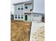 Stylish two-story home featuring gray siding, a bright green front door, and an attached garage at 3813 N Lawndale Ave, Indianapolis, IN 46254