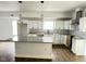 Modern kitchen featuring white cabinets, granite countertops, and an island, ideal for cooking and entertaining at 3813 N Lawndale Ave, Indianapolis, IN 46254