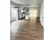 Open-concept kitchen and dining area with hardwood floors and modern white cabinets, creating an airy feel at 3813 N Lawndale Ave, Indianapolis, IN 46254