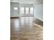 Bright living room with hardwood floors and white walls, complemented by natural light from multiple windows at 3813 N Lawndale Ave, Indianapolis, IN 46254