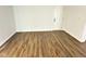 Empty room with hardwood floors, white door and walls, ready for your personal touch at 3813 N Lawndale Ave, Indianapolis, IN 46254