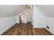 Attic space with wood floors leading to a stairwell and hallway to the main bedroom at 3822 Haverhill Dr, Anderson, IN 46013