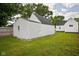 Backyard view featuring a detached garage and a well-maintained lawn at 3822 Haverhill Dr, Anderson, IN 46013