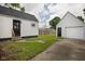 Backyard with a detached garage and a walkway, surrounded by green grass at 3822 Haverhill Dr, Anderson, IN 46013