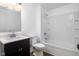 Bright bathroom featuring a sleek black vanity, toilet, and shower with a tub at 3822 Haverhill Dr, Anderson, IN 46013