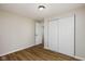 Bedroom featuring neutral paint, wood-look flooring, a closet with sliding doors, and an open doorway at 3822 Haverhill Dr, Anderson, IN 46013