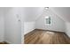 Attic bedroom featuring white walls, wood floors, and a window with a view at 3822 Haverhill Dr, Anderson, IN 46013