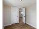 Bedroom with neutral paint, wood-look flooring, white trim, and an open doorway to another room at 3822 Haverhill Dr, Anderson, IN 46013