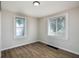 Bedroom with neutral paint, wood-look flooring, white trim, and two windows at 3822 Haverhill Dr, Anderson, IN 46013