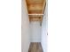 Small walk-in closet with rod for hanging clothes; features wood-look flooring and white walls at 3822 Haverhill Dr, Anderson, IN 46013