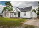 Charming home showcasing a cozy covered front porch and a lush, green front yard, complemented by a driveway at 3822 Haverhill Dr, Anderson, IN 46013