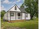 Charming home featuring a covered front porch, and a beautiful lawn, perfect for outdoor enjoyment at 3822 Haverhill Dr, Anderson, IN 46013