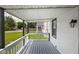View from the covered front porch, showing a well-maintained yard and neighborhood street at 3822 Haverhill Dr, Anderson, IN 46013