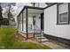 View of the cozy covered front porch, stylish railings, with a well-maintained lawn at 3822 Haverhill Dr, Anderson, IN 46013