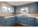 Kitchen with blue cabinets and neutral countertops, complemented by natural light at 3822 Haverhill Dr, Anderson, IN 46013