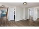 Open-concept living area with wood-look floors, neutral paint, and access to the kitchen and upstairs at 3822 Haverhill Dr, Anderson, IN 46013