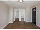 Living room features wood-look flooring, neutral paint, white trim, and a black front door at 3822 Haverhill Dr, Anderson, IN 46013