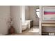 This bathroom boasts a soaking tub, double sinks, and a patterned rug at 3925 Besbie Way, Bargersville, IN 46106