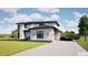 Stylish modern home features a stone exterior, a paved driveway, and lush landscaping at 3925 Besbie Way, Bargersville, IN 46106
