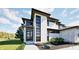 Contemporary home with stone and white exterior, black framed windows, and professionally landscaped front yard at 3925 Besbie Way, Bargersville, IN 46106
