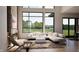 Bright living room features a modern sofa, accent chair, fireplace, and large windows at 3925 Besbie Way, Bargersville, IN 46106