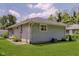 Backyard view features the home's exterior, green lawn, and landscaping, perfect for outdoor living at 4218 E 18Th St, Indianapolis, IN 46218