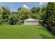 Spacious backyard featuring a detached garage and lush greenery, perfect for outdoor enjoyment at 4218 E 18Th St, Indianapolis, IN 46218