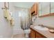 Functional bathroom featuring a shower, toilet, and wood-look vanity at 4218 E 18Th St, Indianapolis, IN 46218